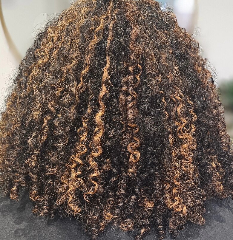 Caramel highlights through natural curls by Riverside Hair