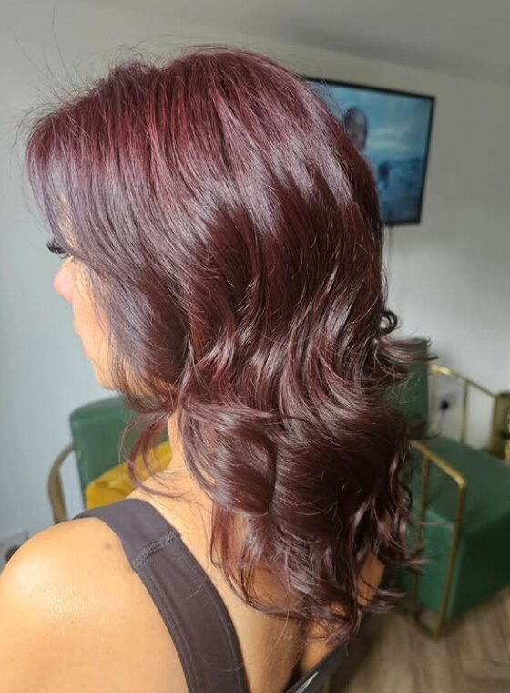 Glossy auburn colour and soft waved finish by Riverside Hair